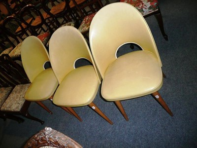 Lot 526 - Set of three 1950's yellow vinyl upholstered beech tub-shaped chairs