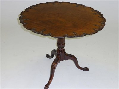 Lot 1420 - A George III Style Mahogany Pedestal Table, the flip-top with moulded pie crust edge and...