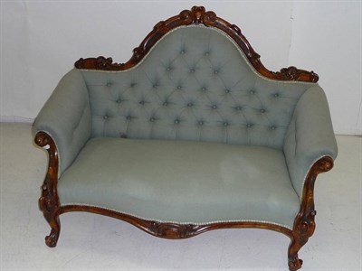 Lot 1422 - A Victorian Walnut Framed Settee, upholstered in green damask, the arched back with scrolling...