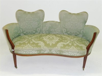 Lot 1423 - An Edwardian Inlaid Mahogany Settee, upholstered in green floral silk damask, the double shaped...