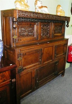 Lot 589 - A carved oak press cupboard