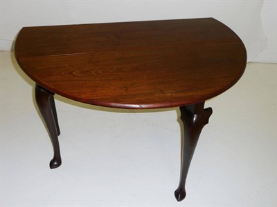 Lot 1428 - A George III Mahogany Dropleaf Table, the oval top incorporating two hinged leaves, on a plinth...