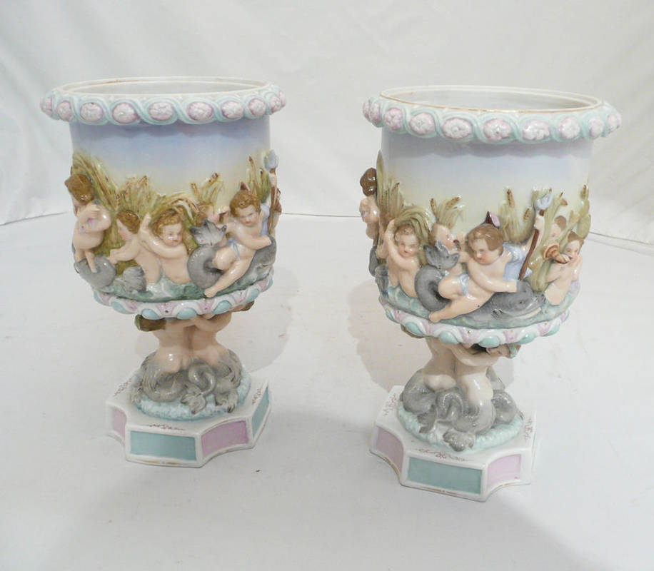 Lot 38 - A pair of Continental pedestal vases decorated with cherubs and mermaids