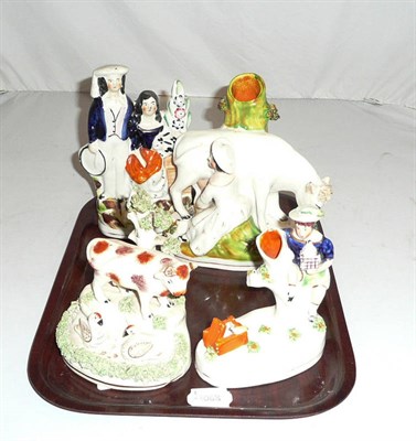 Lot 48 - A Staffordshire figural group with a rabbit and hutch, milking group spill vase; spill vase...