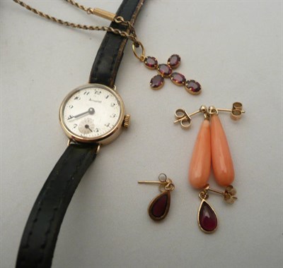 Lot 69 - A garnet cross, two pairs of earrings and a lady's Accurist watch