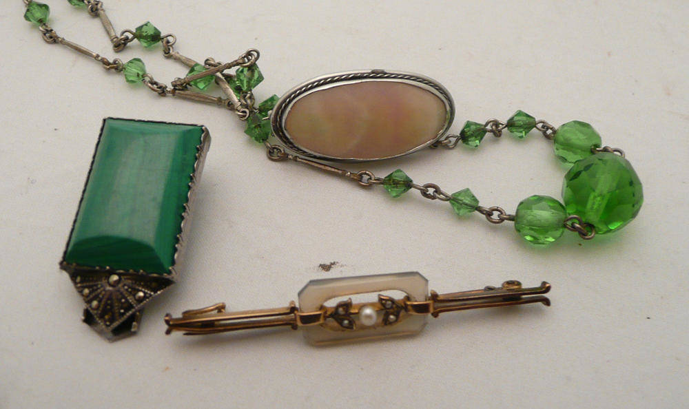 Lot 87 - An Edwardian seed pearl bar brooch, a malachite clip brooch, a mother-of-pearl brooch and a...
