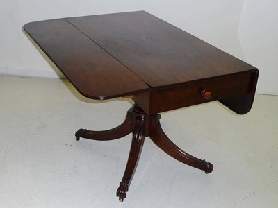 Lot 1439 - A Regency Mahogany Pedestal Pembroke Table, the rectangular top with two rounded drop leaves...