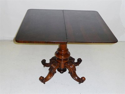 Lot 1440 - A Victorian Rosewood Foldover Tea Table, the rectangular top with moulded edge above a plain...