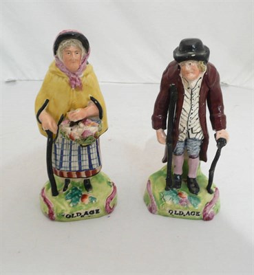 Lot 116 - A pair of Staffordshire figure groups 'Old Age'