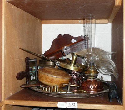 Lot 132 - A shelf of ornamentals including brass and copper chambersticks, hand mirror, oil lamp, fly...