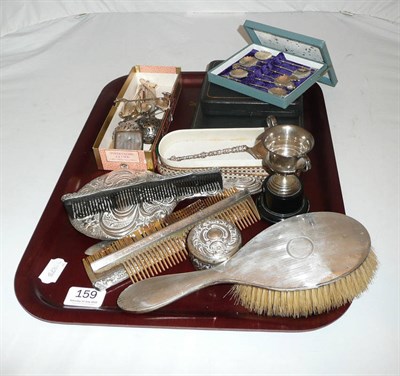 Lot 159 - Tray of silver items including hairbrush, combs, hand mirror, small trophy cup, cased flatware,...