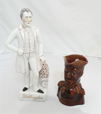 Lot 161 - A Staffordshire figure of Wellington and a 19th century treacle glazed Wellington jug (2)