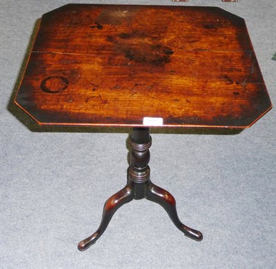 Lot 1455 - A George III Mahogany Tripod Table, the rectangular top with angled corners, on a ring turned...