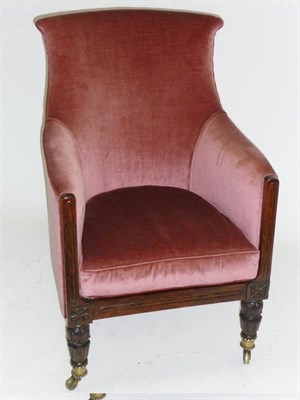 Lot 1464 - A George IV Simulated Rosewood Bergere, upholstered in pink "velvet", the tub-shaped scroll...