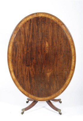 Lot 1476 - A George III Mahogany and Rosewood Breakfast Table, the oval top above a ring turned and...