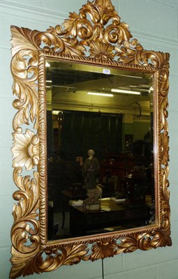 Lot 1478 - A Florentine Giltwood Wall Mirror, early 19th century, the rectangular bevelled glass plate...