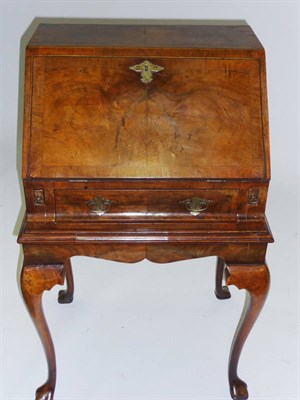 Lot 1494 - An Early 20th Century Walnut Bureau in George II Style, the fall front opening to reveal a...