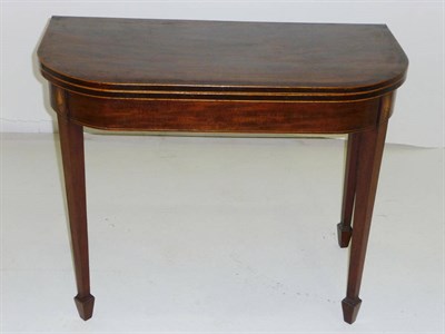 Lot 1509 - A George III Mahogany Crossbanded Card Table, the rounded top above a plain frieze flanked by...