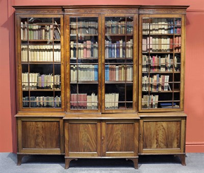 Lot 1535 - A Late George III Mahogany Four Door Breakfront Bookcase, the projecting moulded cornice above...