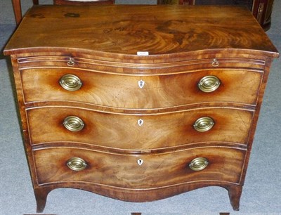 Lot 1536 - A George III Mahogany Serpentine Commode, the rectangular top above a pull-out brushing slide, with