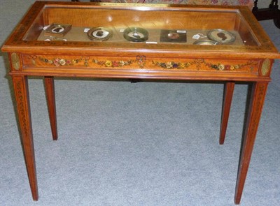 Lot 1549 - An Edwardian Painted Satinwood Bijouterie Table, with glazed rising top and standing on square...