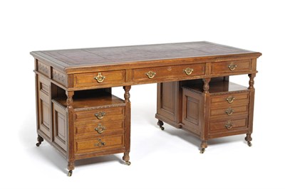 Lot 1557 - A Walnut Desk, the moulded top inset with tooled red leather over three frieze drawers, the...