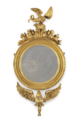 Lot 1563 - A George III Giltwood Mirror, the circular silvered mirror plate within a guilloche and beaded...