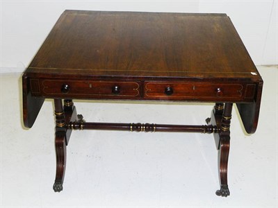 Lot 1573 - A Regency Rosewood and Brass Inlaid Sofa Table, the rectangular top with twin D shape drop...