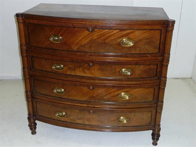 Lot 1574 - A Regency Mahogany Bowfront Secretaire Chest, the shaped top with reeded edge above a deep...