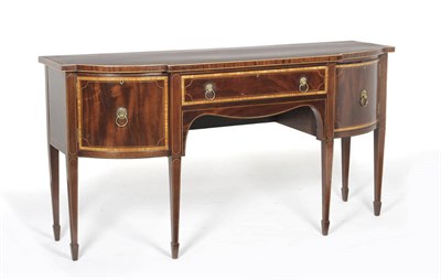 Lot 1575 - A George III Mahogany and Satinwood Banded Breakfront Sideboard, the central frieze drawer...