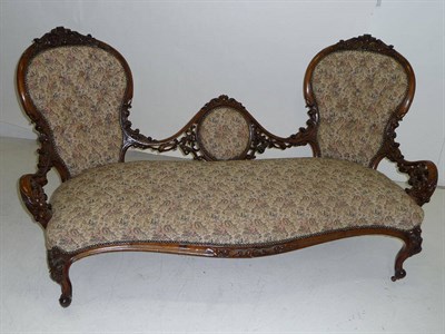 Lot 1580 - A Victorian Walnut Framed Settee, upholstered in floral needlework print damask, the double...