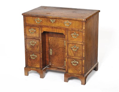 Lot 1586 - A George II Walnut Kneehole Dressing Table, the crossbanded rectangular top over a single...