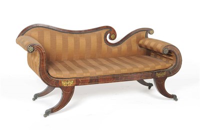 Lot 1594 - A Regency Rosewood and Brass Inlaid Chaise Longue, upholstered in pink and gold striped silk...