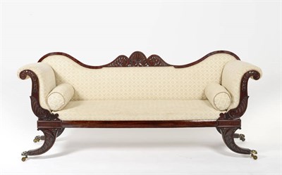 Lot 1606 - A Regency Mahogany Settee, upholstered in cream floral damask, the double ended scrolling back...