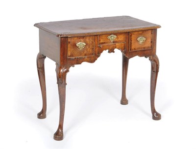 Lot 1607 - A George II Walnut and Crossbanded Lowboy, the rounded rectangular top above a single frieze drawer