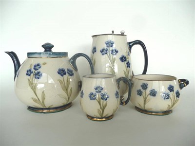 Lot 1621 - A Moorcroft Macintyre Dura Ware Tea Service, tube-lined with forget-me-nots, comprising teapot...