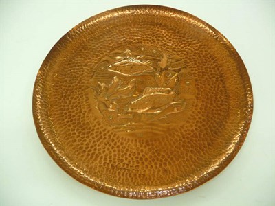 Lot 1678 - A Newlyn Copper Charger, the centre embossed with fish swimming in reeds, within a hammered...