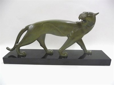 Lot 1679 - An Art Deco Patinated Bronze of a Jaguar, on a rectangular polished slate base, hind paw...