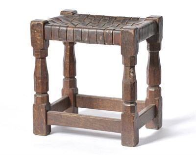 Lot 1701 - A Robert "Mouseman" Thompson Oak Stool, with lattice leather top on four octagonal legs joined...