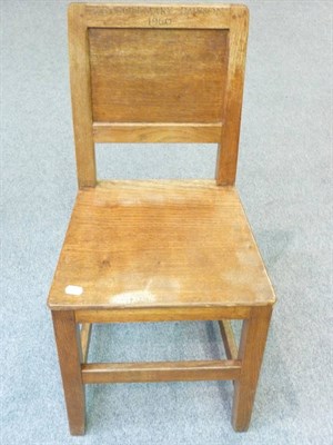 Lot 1714 - Six Robert "Mouseman" Thompson Oak Panel Back and Seat Chairs, on square section legs, joined...