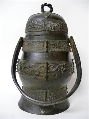 Lot 146A - A Chinese Cast Bronze Archaic Swing Handled Vessel with Cover, the domed cover and body with...