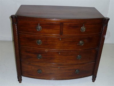 Lot 1594A - A Regency Mahogany Bowfront Chest, the strung top with moulded edge above two short and three...