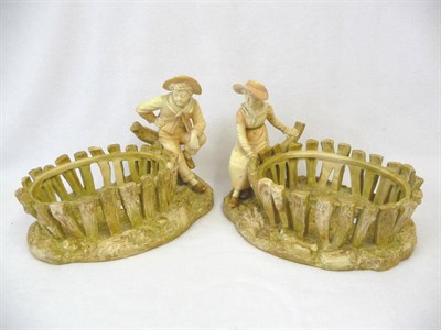 Lot 80 - A Pair of Hadleys Worcester Porcelain Figural Table Baskets, late 19th century, modelled as a young