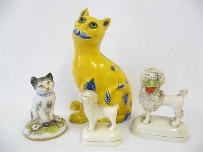 Lot 95 - A Staffordshire Pottery Poodle, circa 1840, the lion dog standing holding a plant pot brimming with