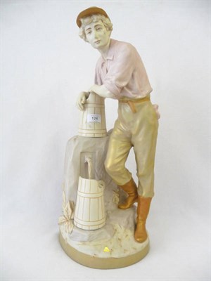 Lot 124 - A Royal Dux (Bohemia) Figure of a Water Carrier, 20th century, as a young man wearing a peaked cap