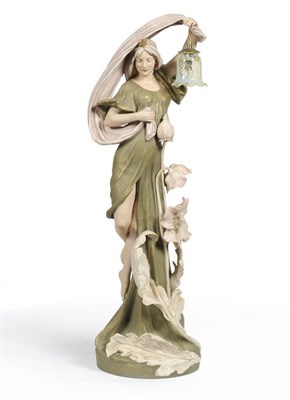 Lot 125 - A Royal Dux (Bohemia) Art Nouveau Figural Lamp, circa 1910, modelled as a maiden wearing an...