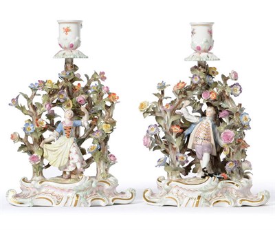 Lot 144 - A Pair of Meissen Encrusted Porcelain Figural Chambersticks, circa 1875, as a couple in 18th...