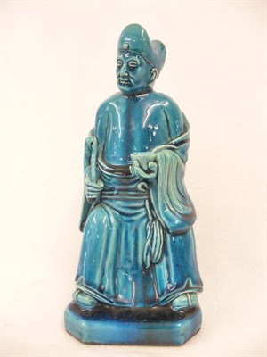 Lot 154 - A Chinese Monochrome Blue Glazed Figure of a Seated Confucian Scholar, 19th century, holding a...