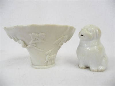 Lot 156 - A Chinese Dehua Porcelain Rhino Horn Shape Libation Cup, circa 1700, applied with tiger, deer...