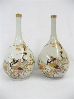 Lot 159 - A Pair of Japanese Porcelain Bottle Vases, early 18th century, each painted with a pair of...